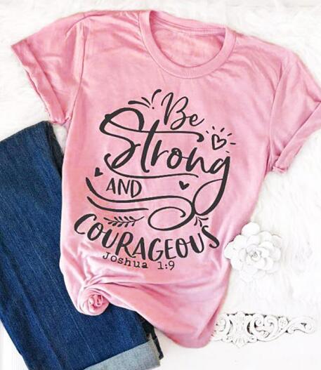 Spruced Roost T-Shirts pink tee black text / L Be Strong and Courageous Tshirt - S-3XL - 4 Colors